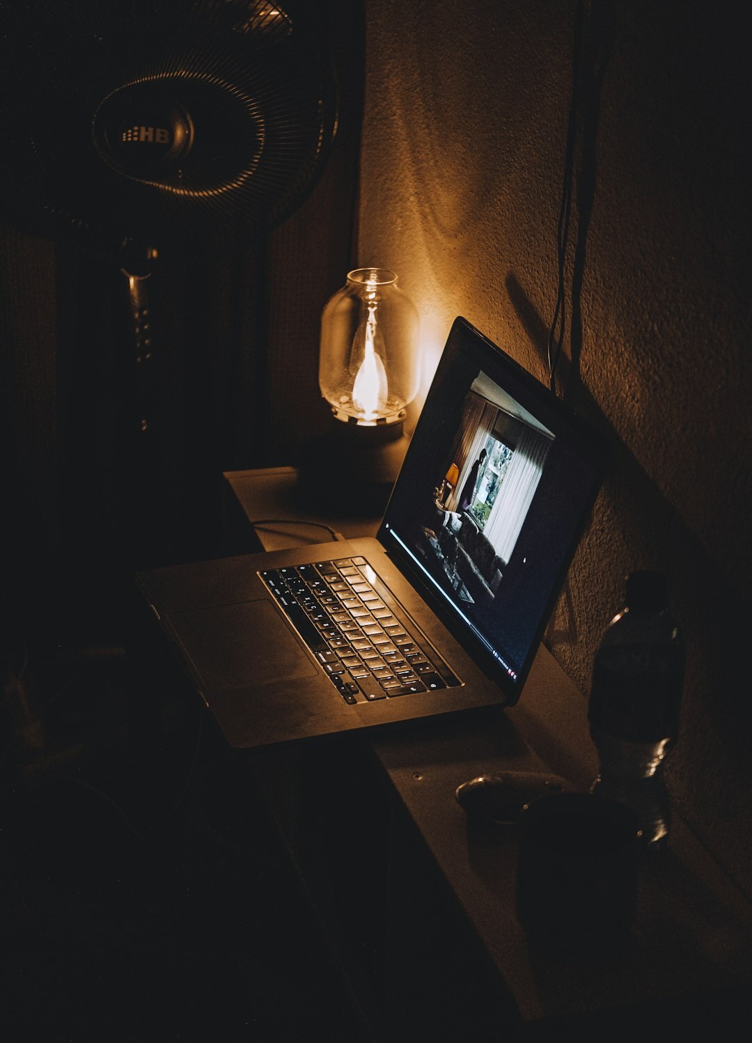 Editor's desk with laptop showing a news website at night