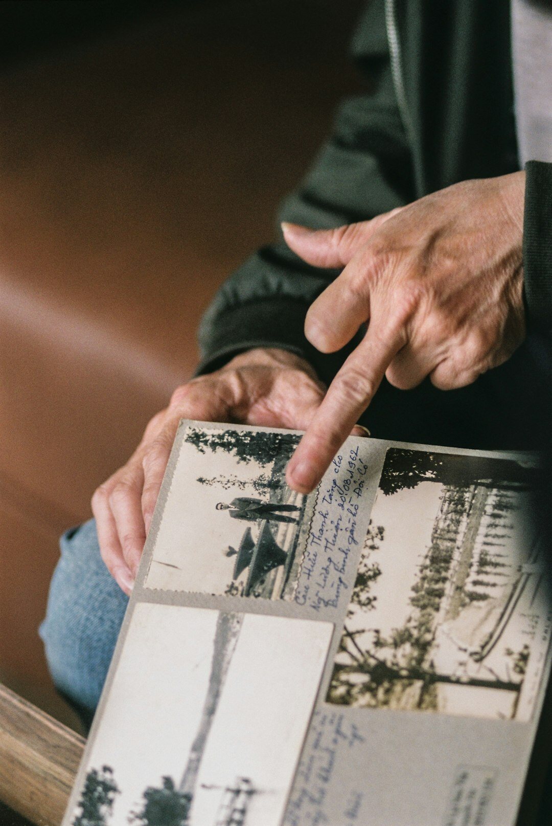 Close up of hands reviewing printed photographs and articles